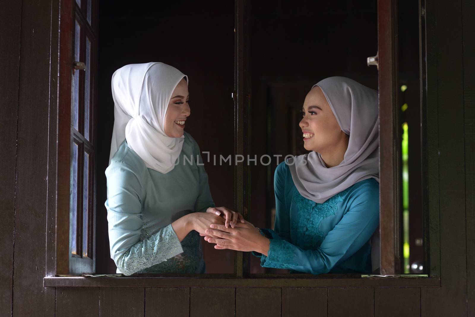 Asian Malay Muslim girls greetings during Hari Raya Aidilfitri. Malaysian people living lifestyle.