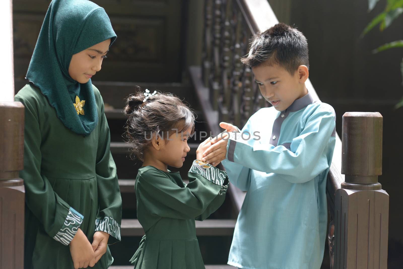 Muslim children greeting, Hari Raya Eid Al-Fitr concept. 