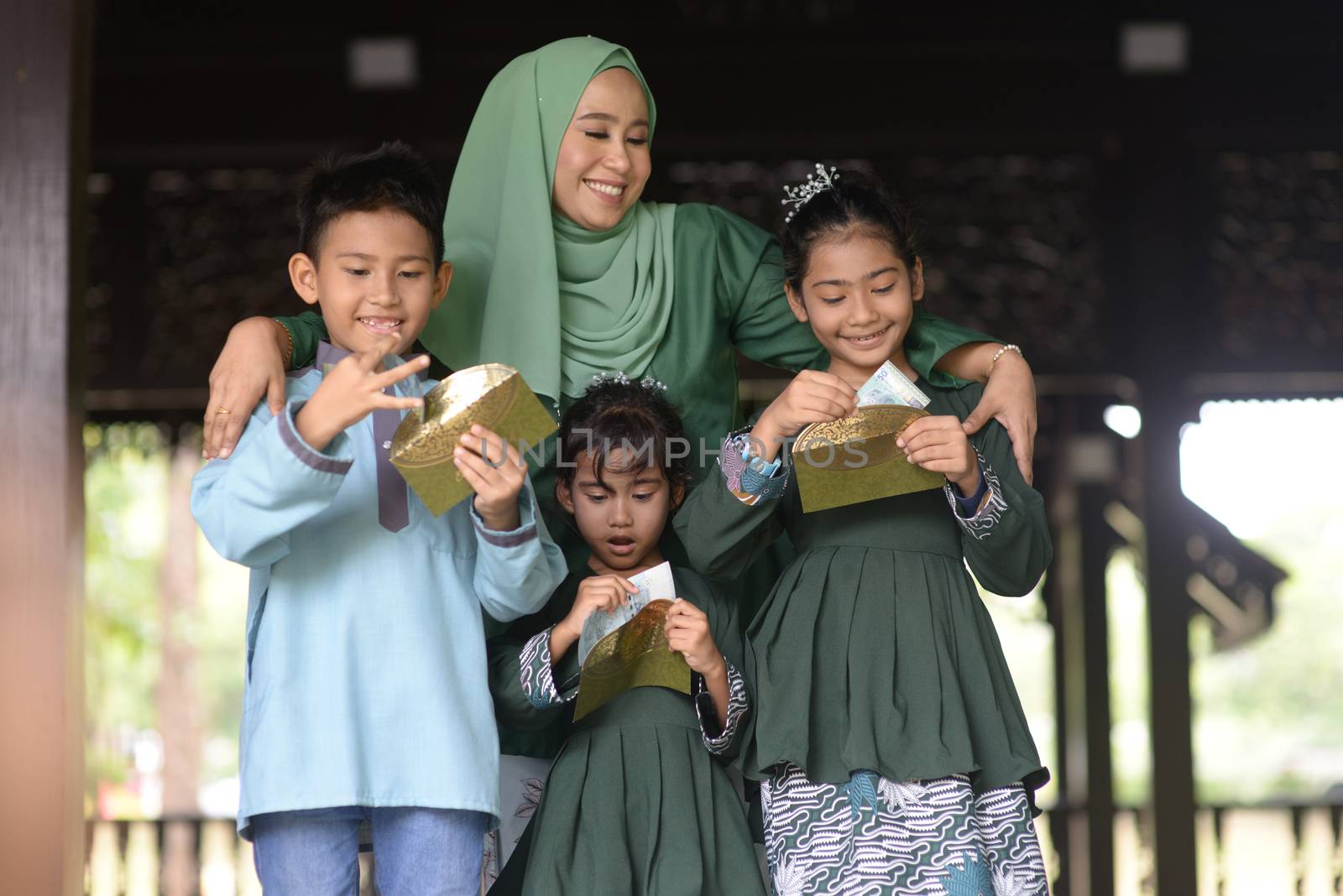 Muslim family, children received money packet as blessing, Hari Raya Eid Al-Fitr concept. 