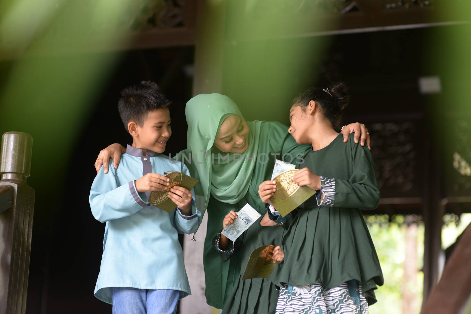 Muslim family, children received money packet as blessing, Hari Raya Eid Al-Fitr concept. 