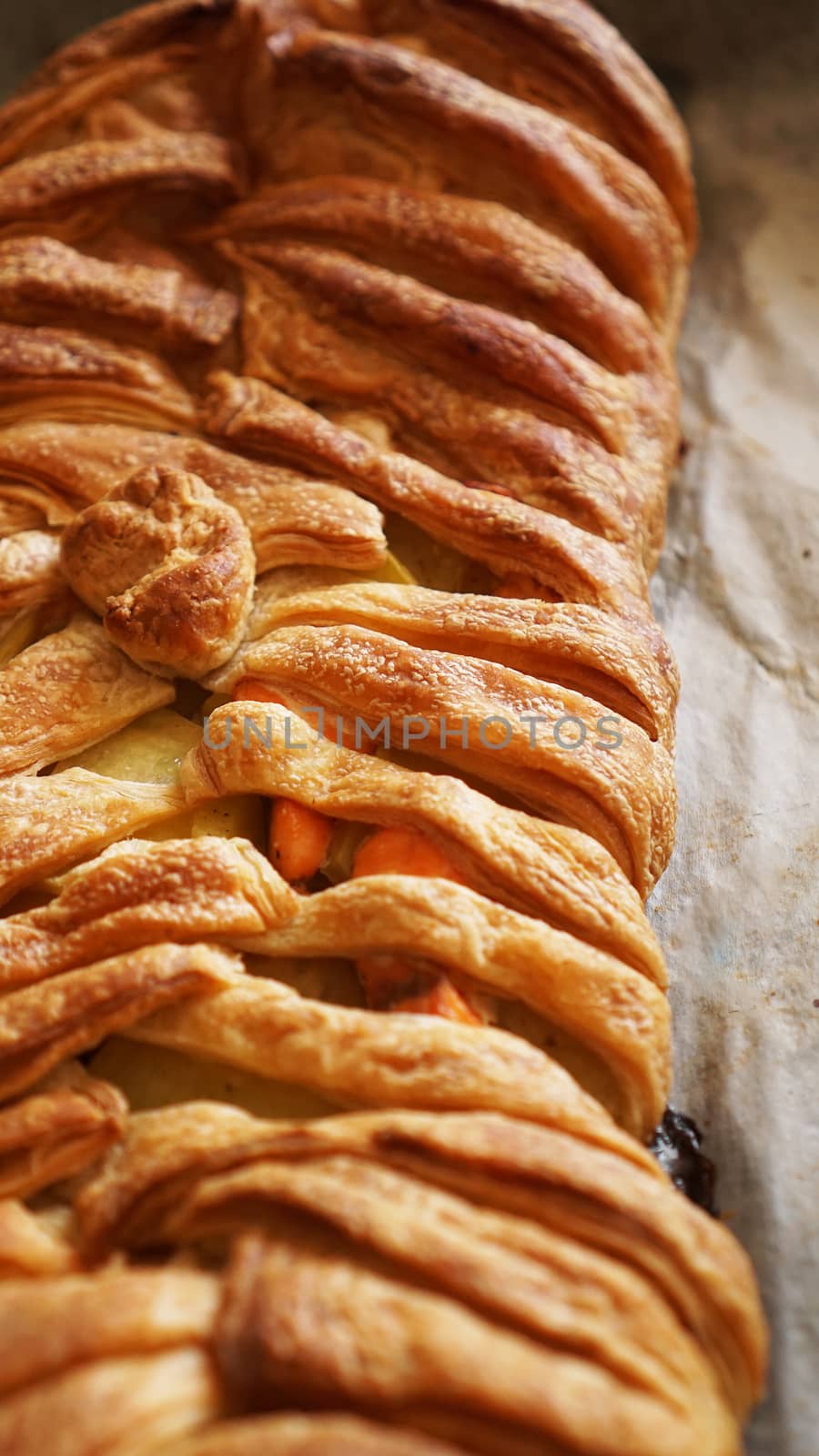 Meat pie with puff pastry. Beautiful golden crust. Crispy Tasty Lunch. vertical photo