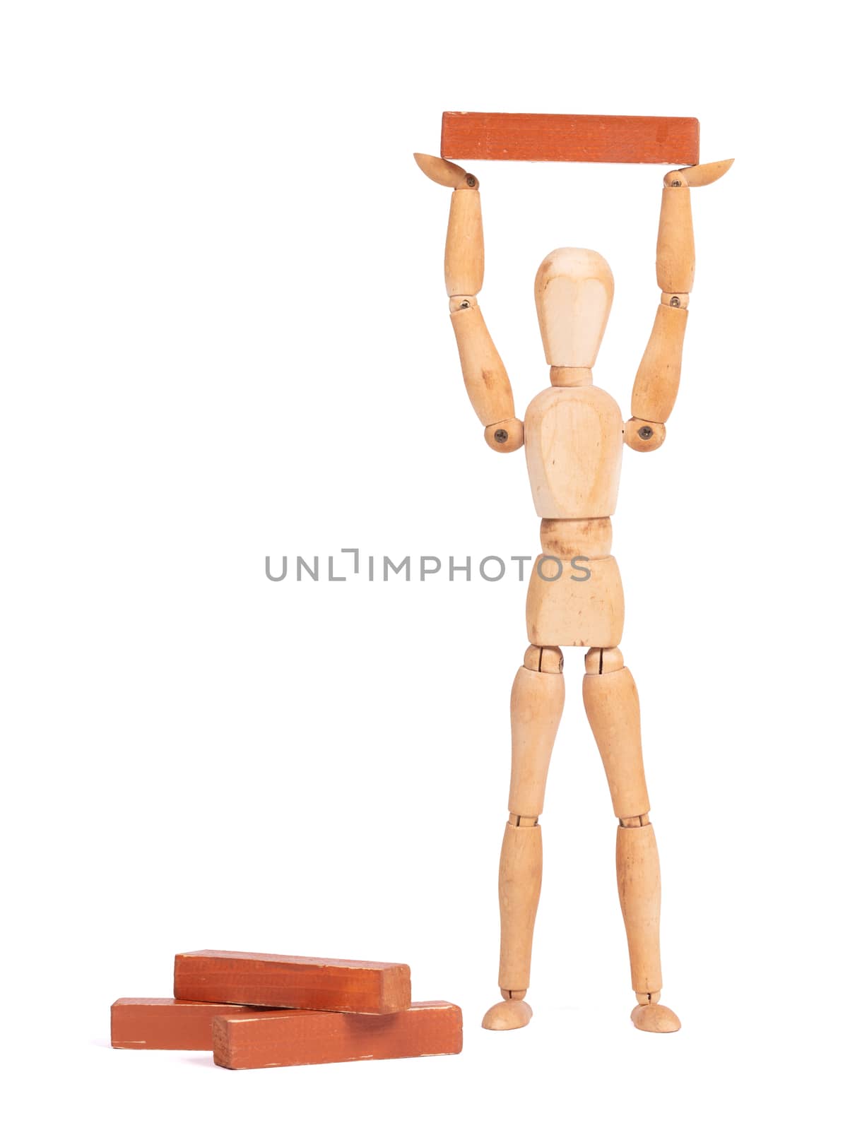 Wooden mannequin carrying a wooden block, isolated on white