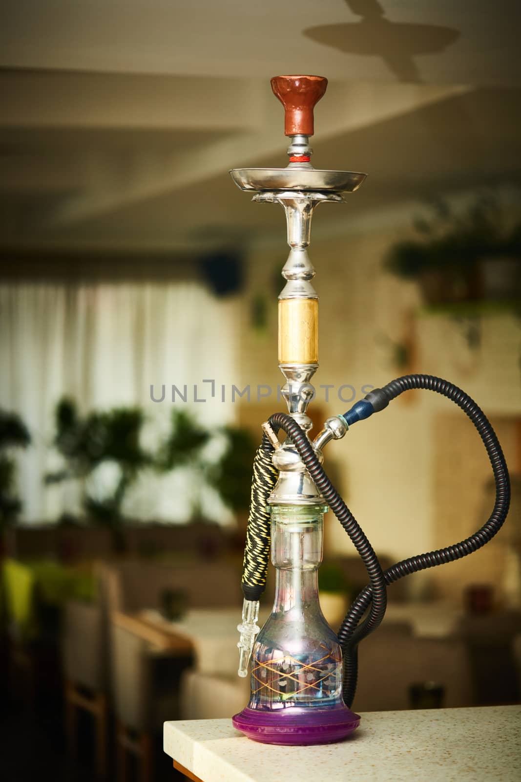 Wood hookah on table in hookah lounge. Shallow dof