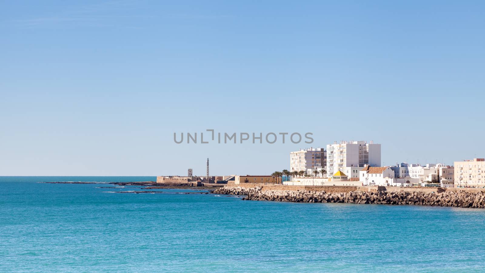 The Cadiz waterfront in Spain with the Castillo de San Sebastian in the background.