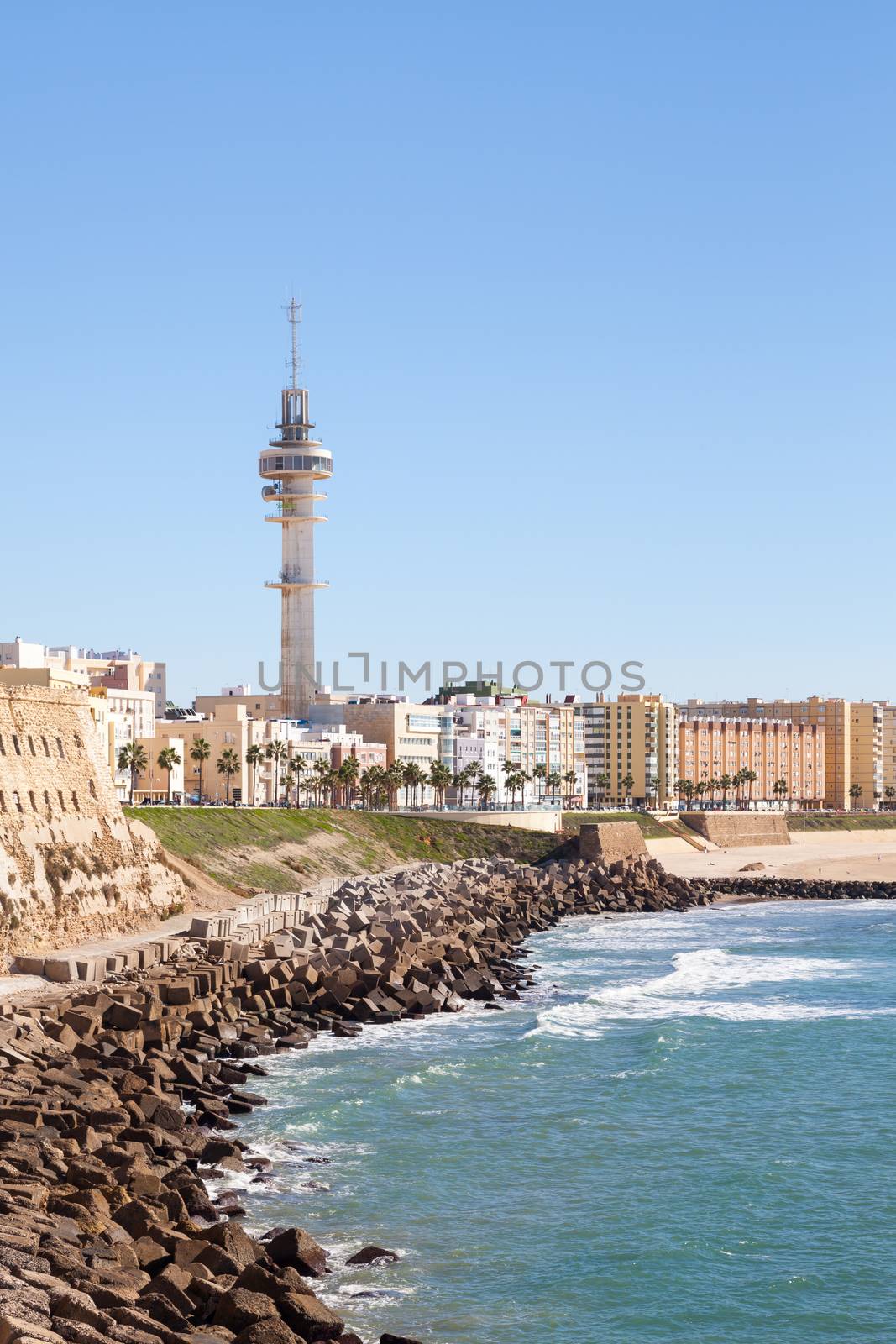 Cadiz waterfront in Spain and the view along the beach of Santa Maria del Mar.