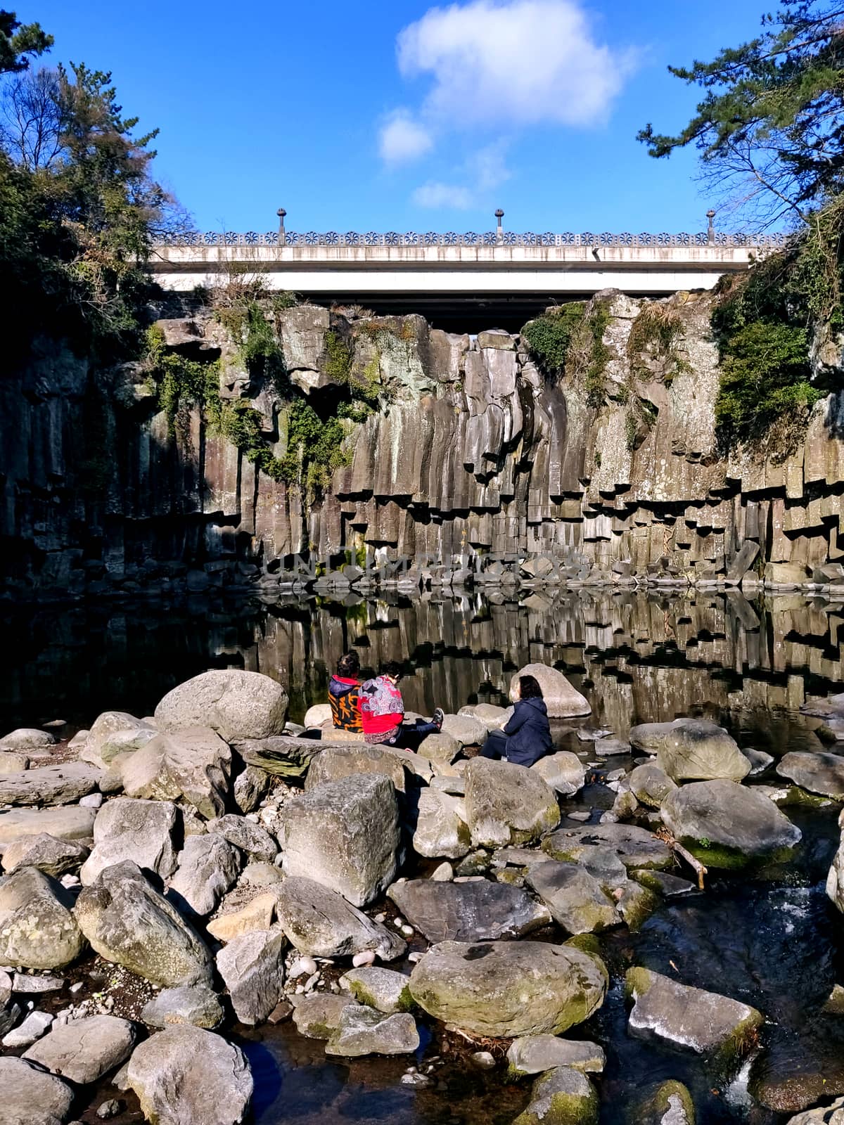 Three old women spending time at the end of a waterfall by mshivangi92