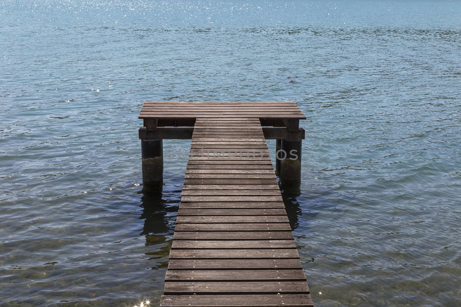 wooden pier surrounded by the blue sea