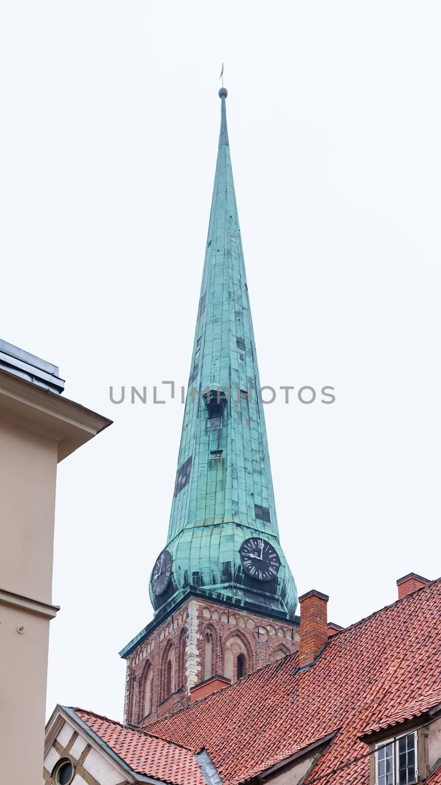The view across rooftops looking towards St Peter's Church in Riga, Latva.  In 1997 the church was included as a UNESCO world heritage site.