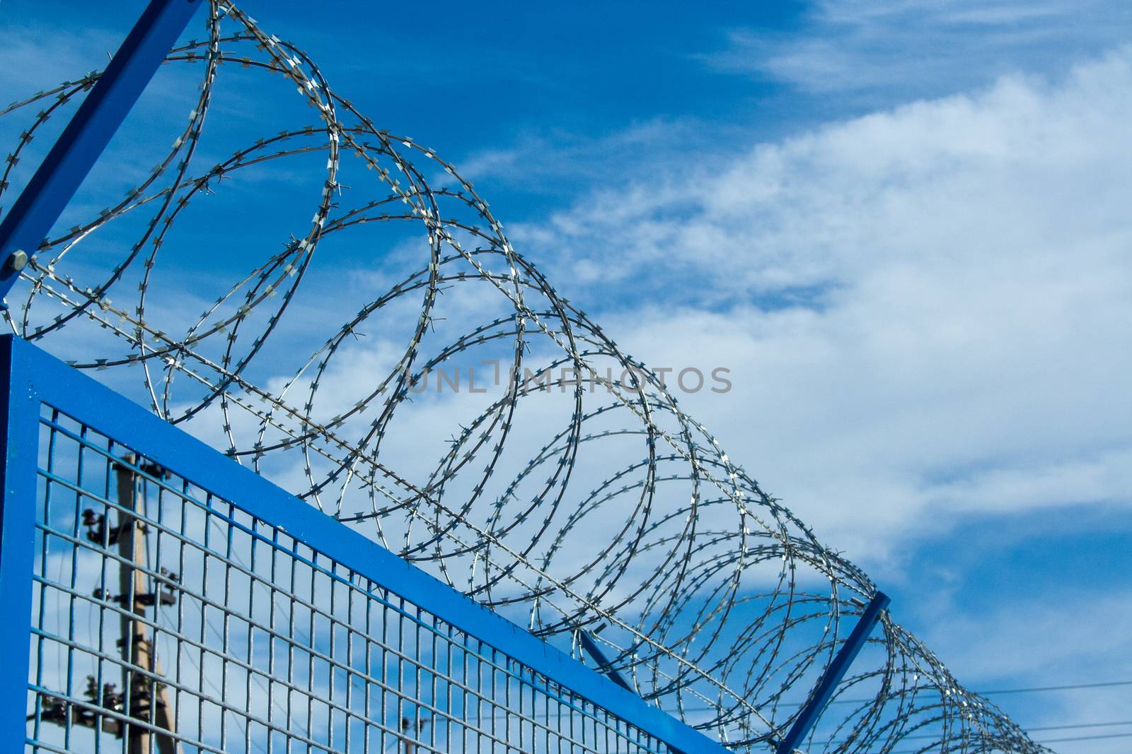 Barbed wires on clear sunny day, security concept