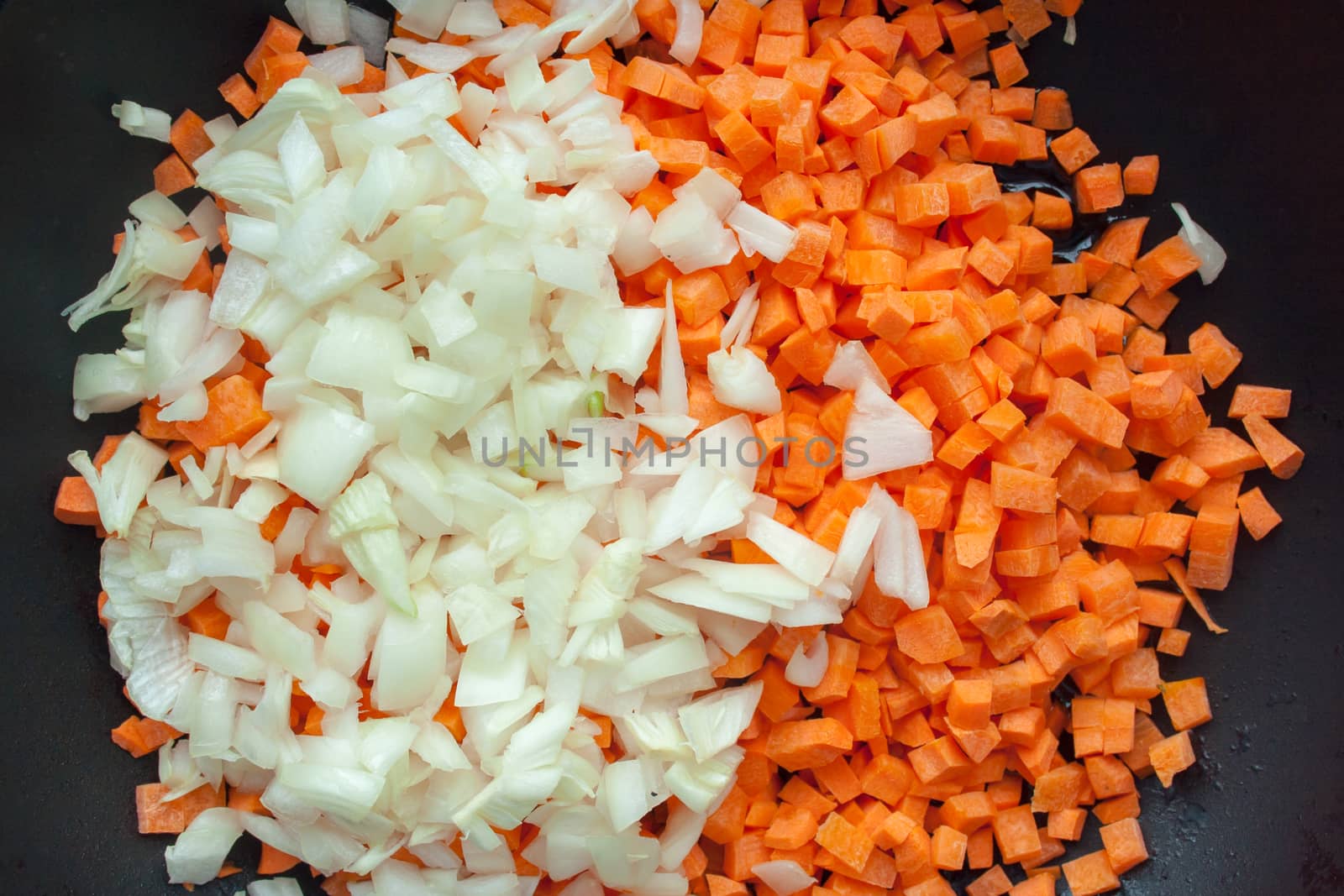 Carrot and onion cutted on black pan background