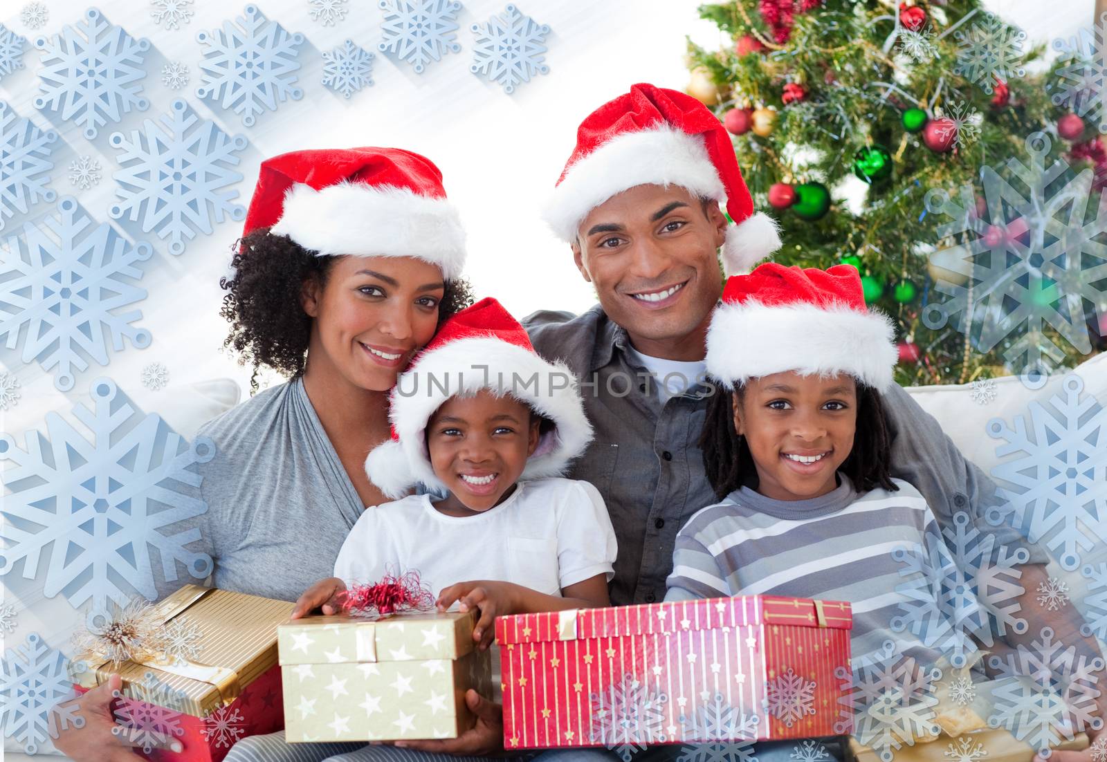 Composite image of family holding Christmas presents against snowflake frame