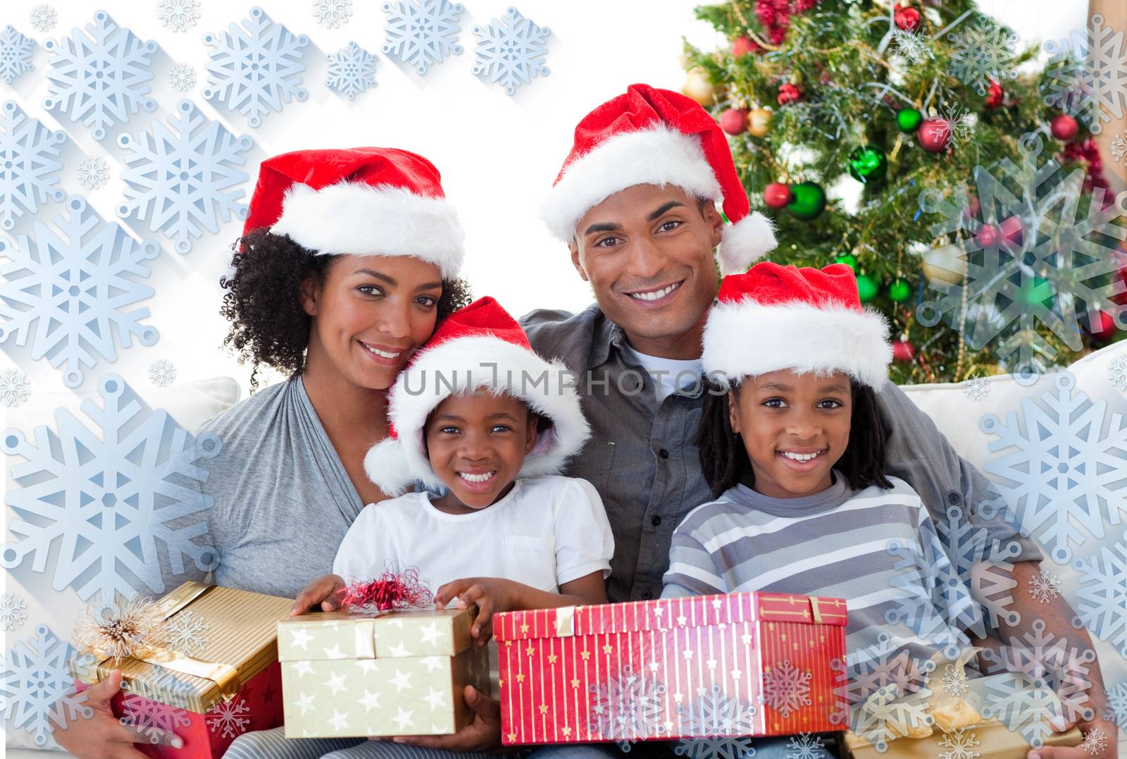 Composite image of family holding Christmas presents against snowflake frame