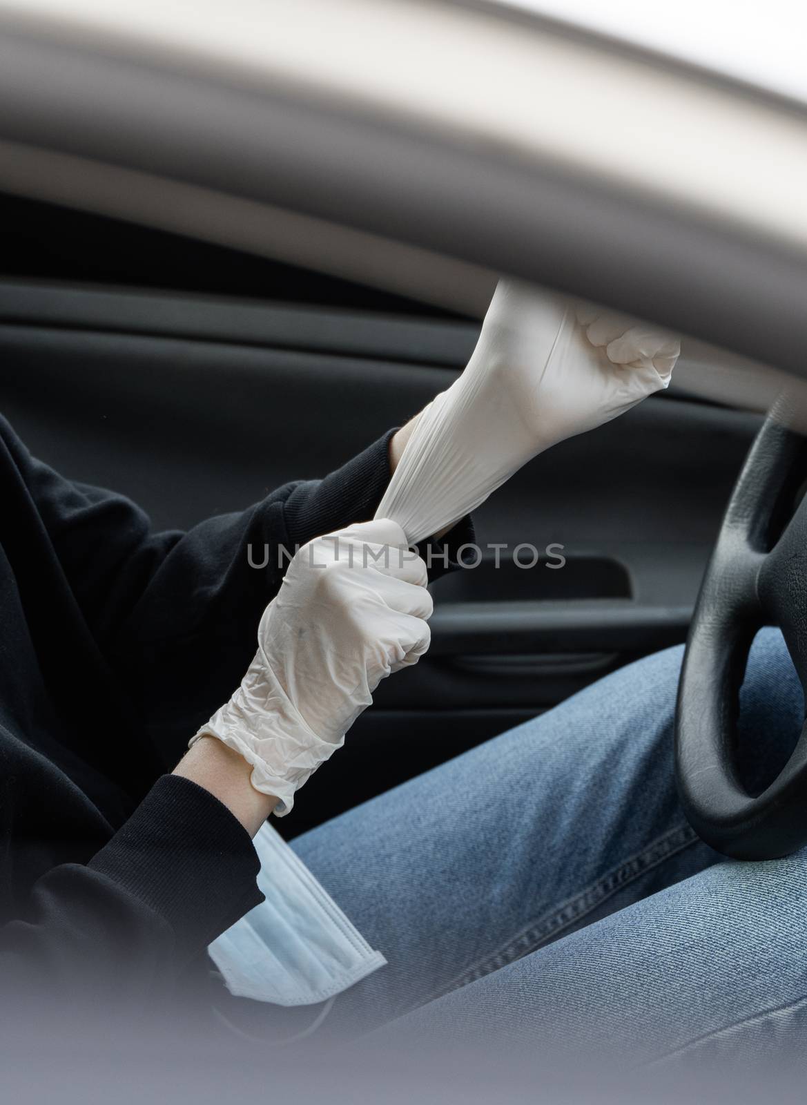Woman in protective medical mask is wearing rubber gloves for protect himself from bacteria virus while planning to drive. Protective mask while quarantine, pandemic, covid 19, coronavirus, infection