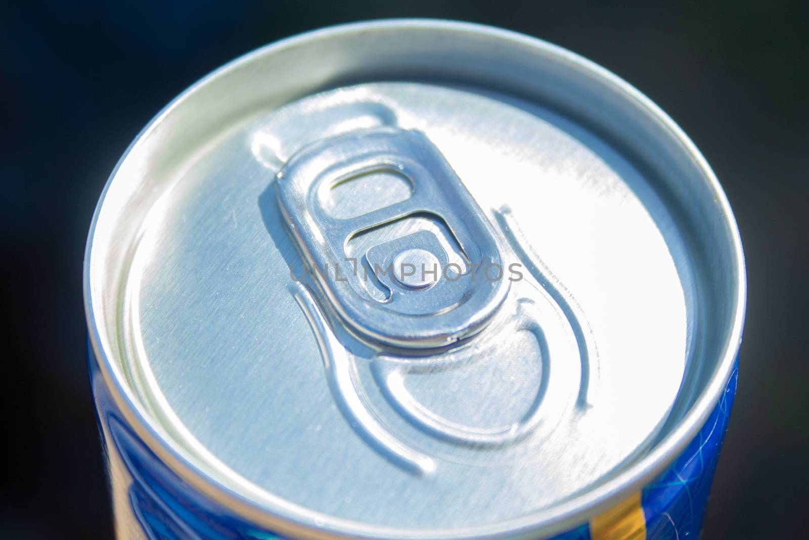 Can of beer close up at sunny day. Fresh drink at warm day. Metallic can with cold drink. Alcohol drink. 