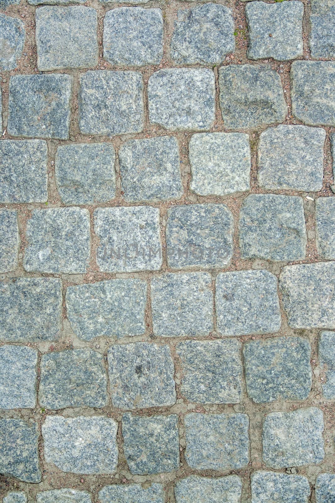 Old aged granite paving stones. Texture of old granite paving stones. The texture of the pavement granite pattern wallpaper for design. Rough texture
