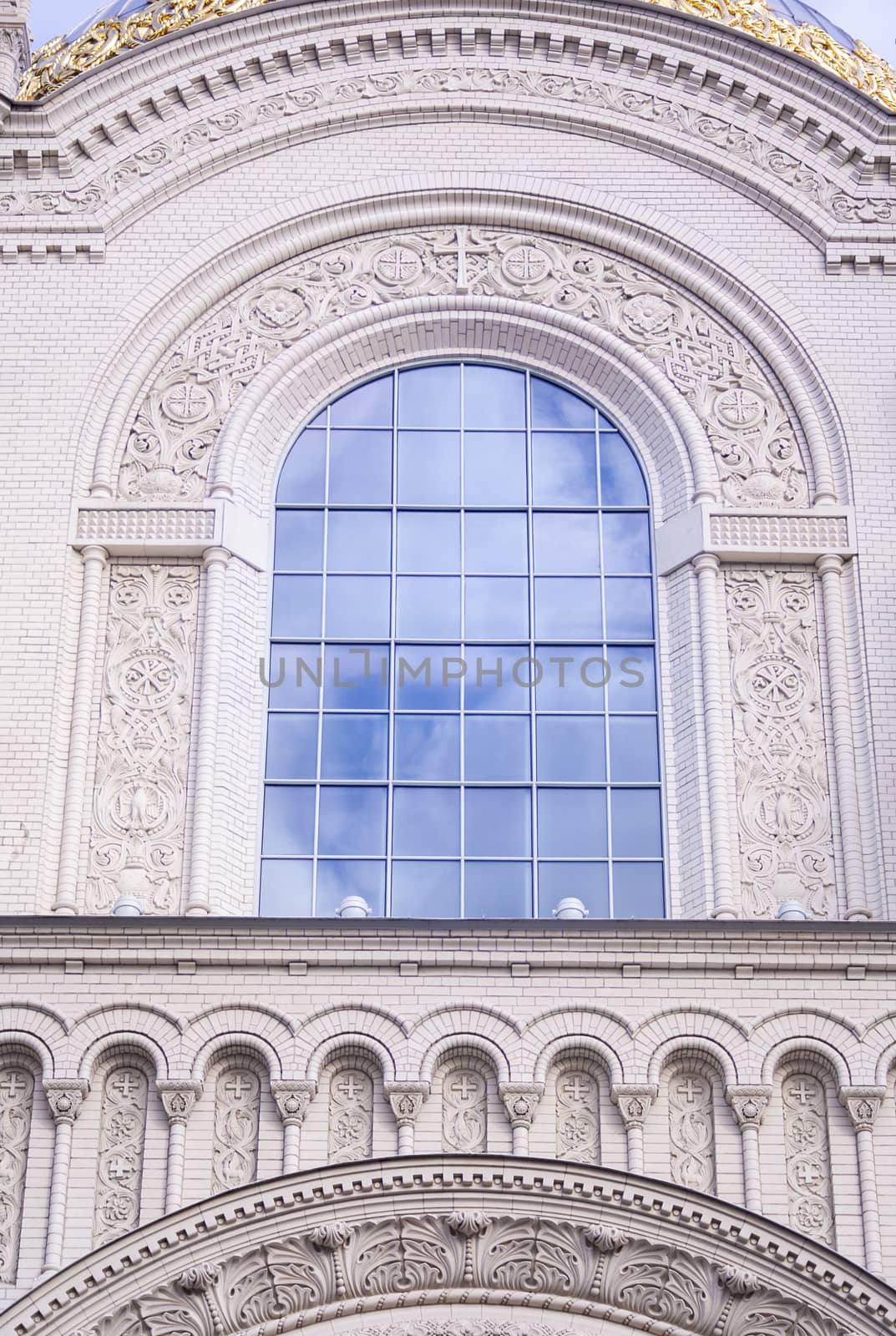 Close up of window on church. Old window on ancient Christian orthodox cathedral. Blue sky in window. Architecture exterior with windows