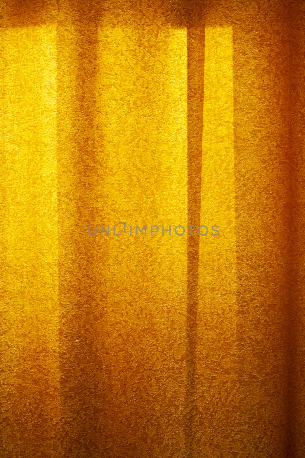 Red curtain background in sunset light. Curtain cloth texture dark vertical