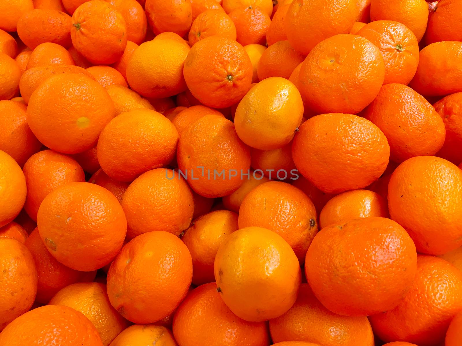 Fresh tangerines on a market stall. Fresh mandarin oranges fruit or tangerines as background