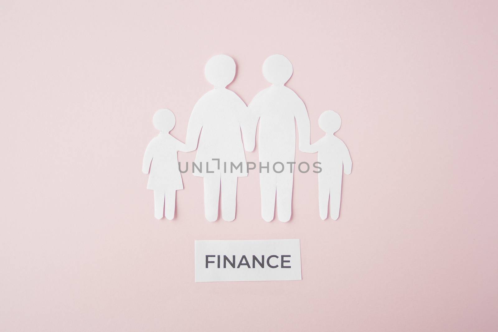 paper family cut out on bright pink background, family home, foster care, family mental health, budget and money concept. Paper family with phrase quote finance 