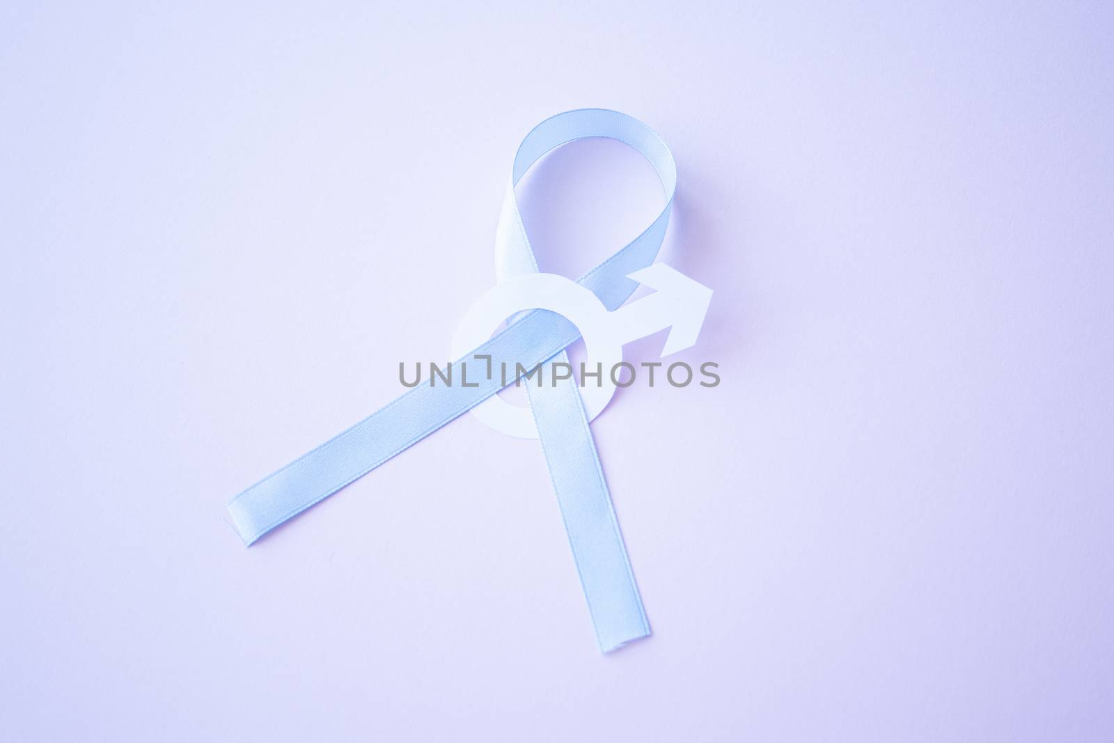 Prostate cancer awareness blue ribbon with white paper male sign mars arrow on pink background. Men healthcare concept, men carcinoma symbol.