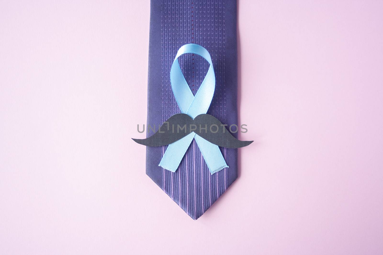 Prostate Cancer Awareness, light Blue Ribbon with mustache on blue men tie for support people living and illness. Men Healthcare and World cancer day concept. Men carcinoma health symbol
