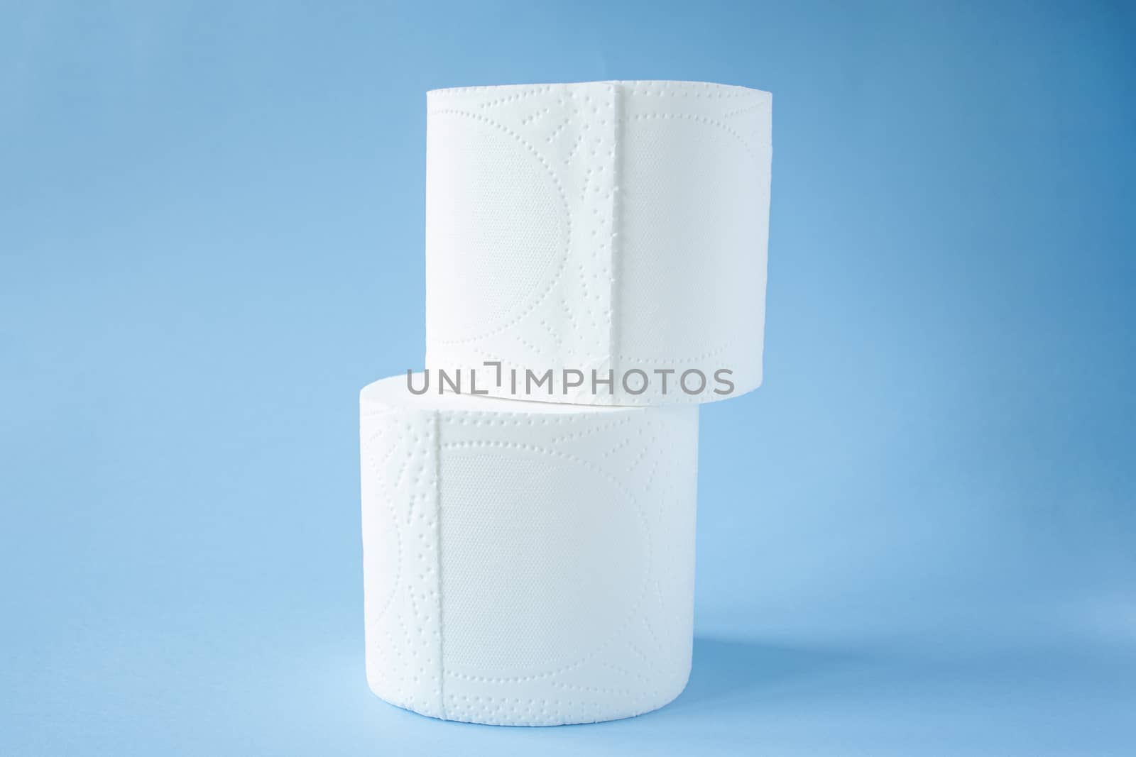 two Toilet paper roll on a blue background top view. Toilet paper purchase due to kronavirus concept. Personal hygiene and stopping the spread of the virus. Cleanliness, Hygiene, Sterility