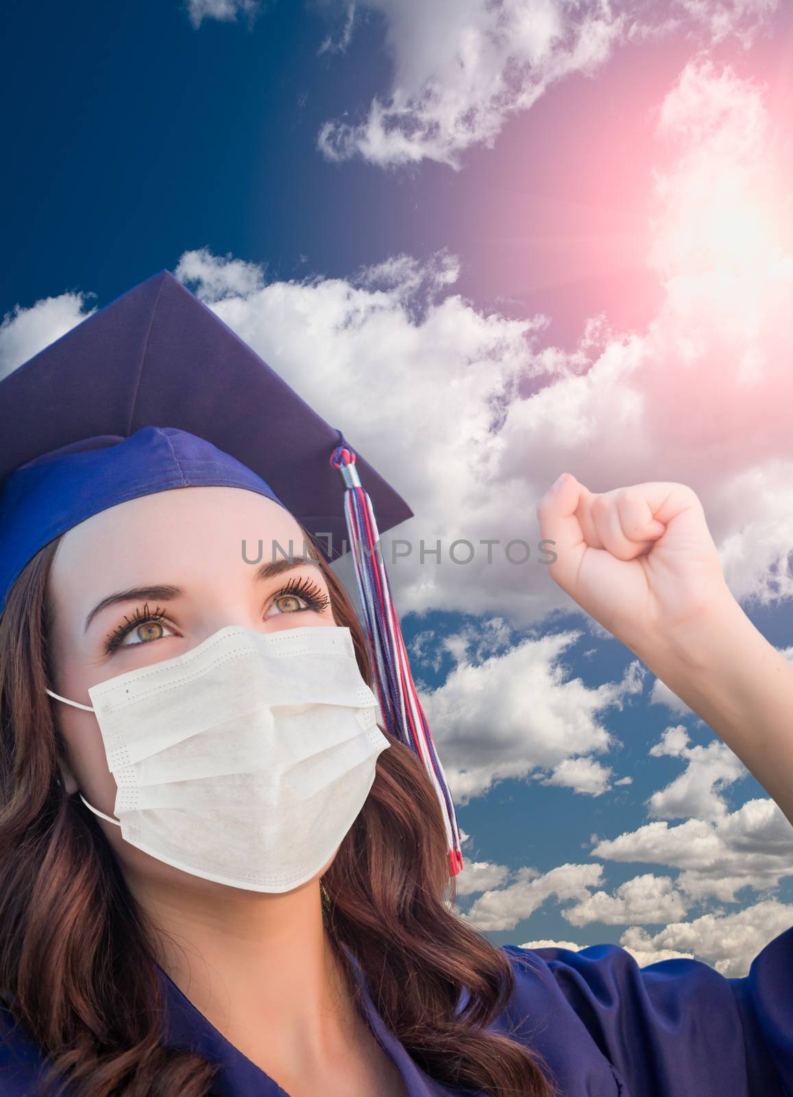 Female Graduate in Cap and Gown Wearing Medical Face Mask.