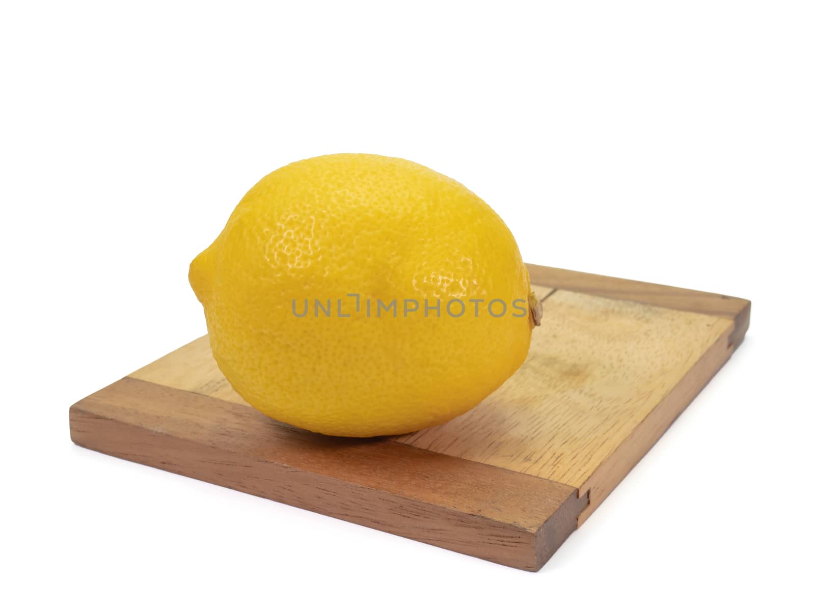 The close up of  fresh yellow lemon organic food on small wooden board on white background.