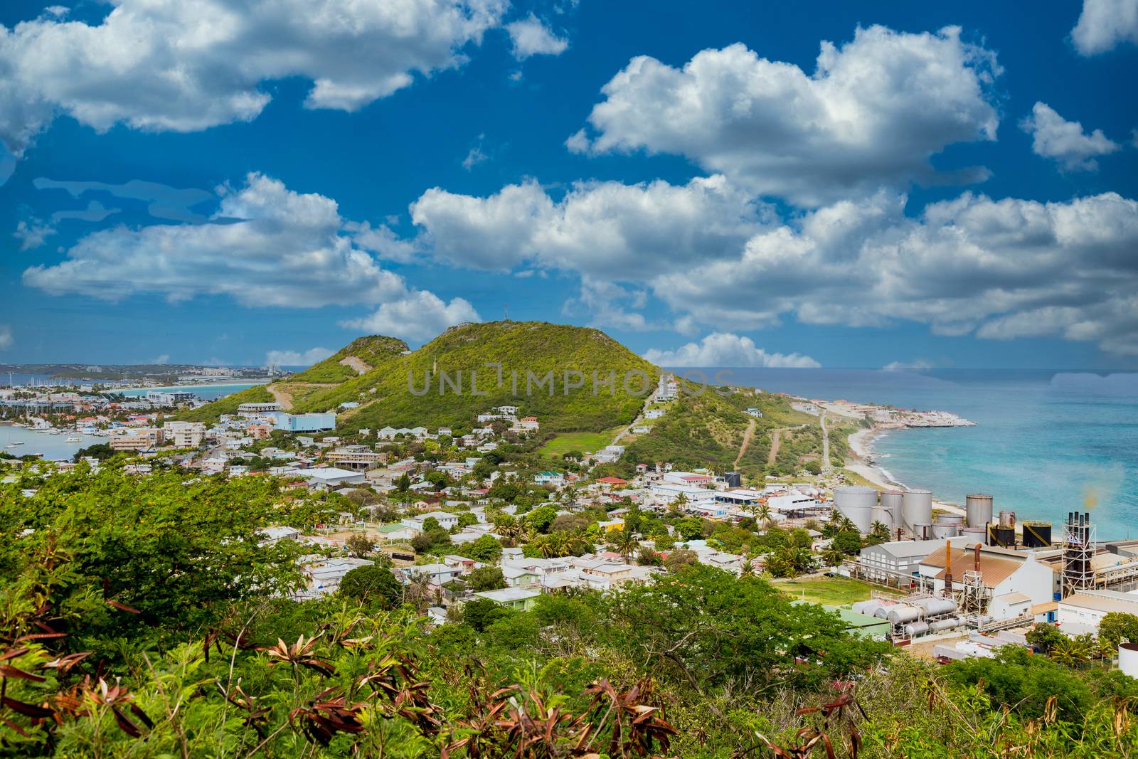 A view of bay on St Martin from hill with sugar factory on coast