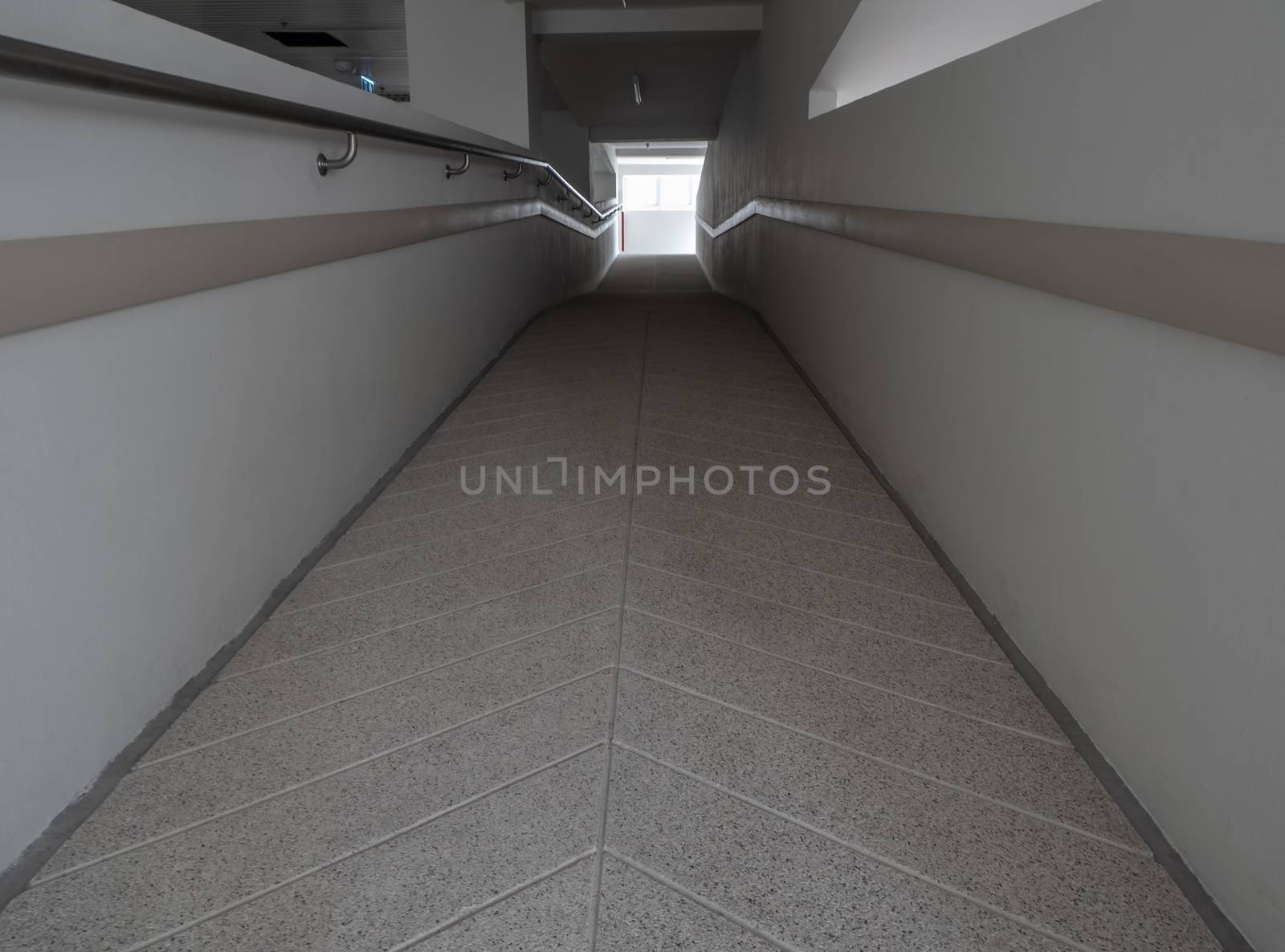 Light at the exit of the corridor in the building by Satakorn