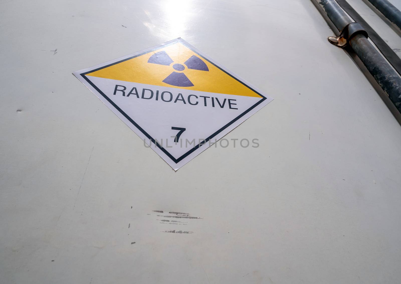 Radiation warning sign on the Hazardous materials transport label Class 7 at the aluminum container of transport truck