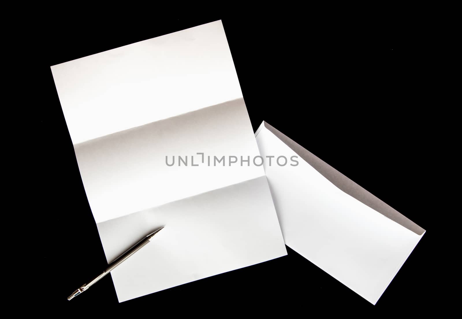 blank of letter paper and white envelope with pen by Satakorn
