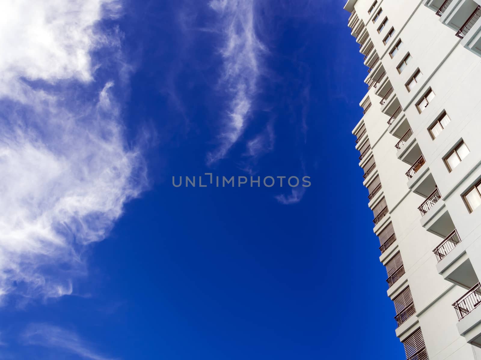 High-rise building and bright blue sky by Satakorn
