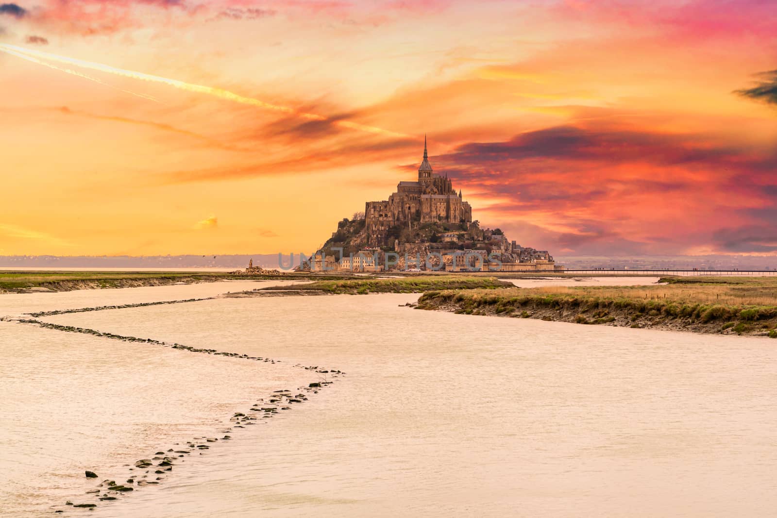 Beautiful view of famous historic Le Mont Saint-Michel tidal island, Normandy, France in beautiful evening twilight at dusk