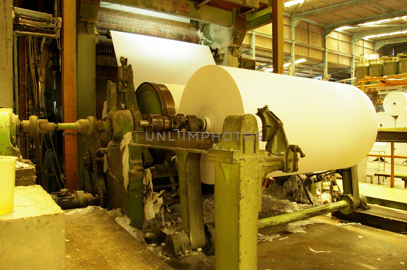 Tissue paper rolled on machine in factory line by Satakorn