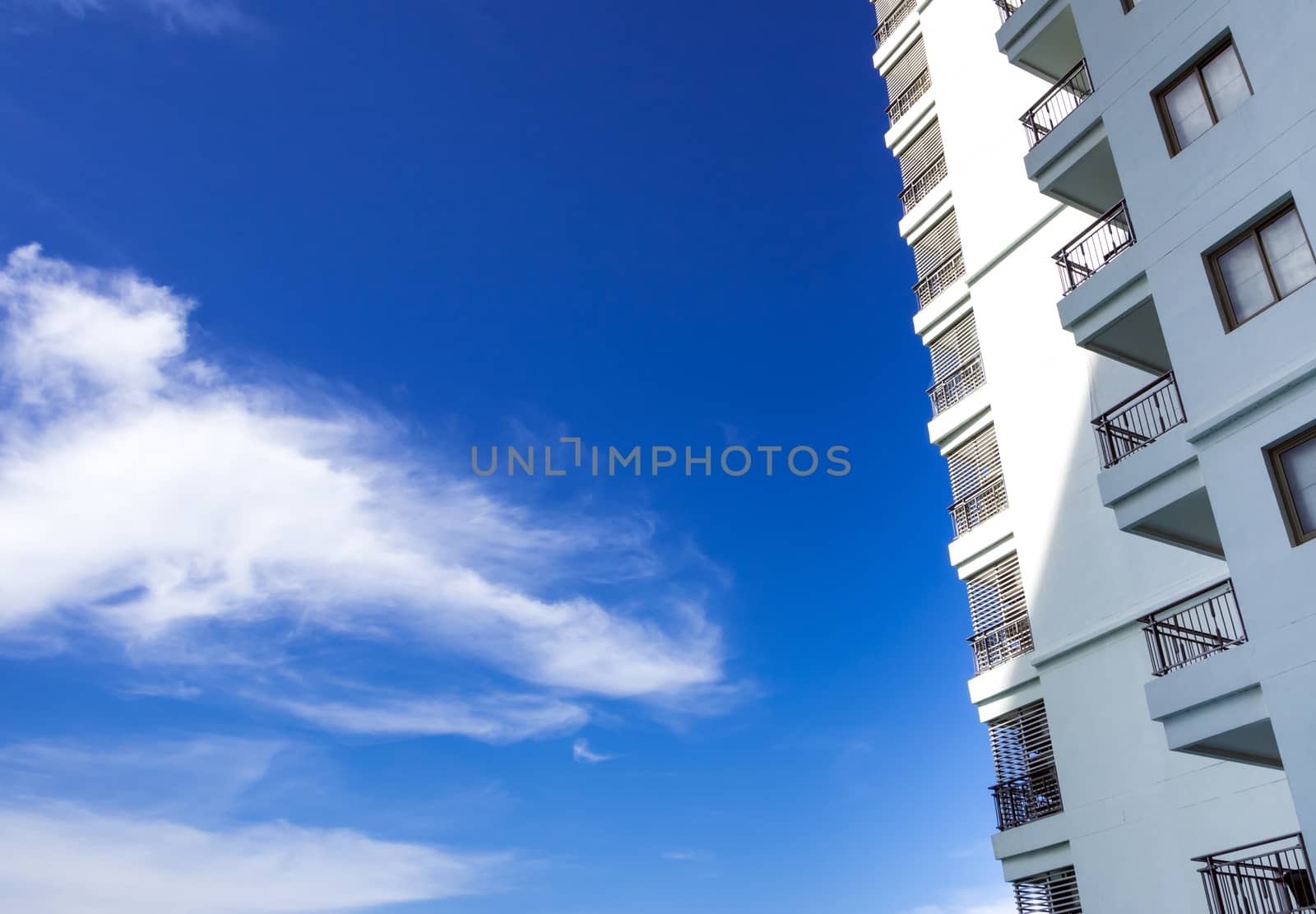 High-rise building and bright blue sky by Satakorn