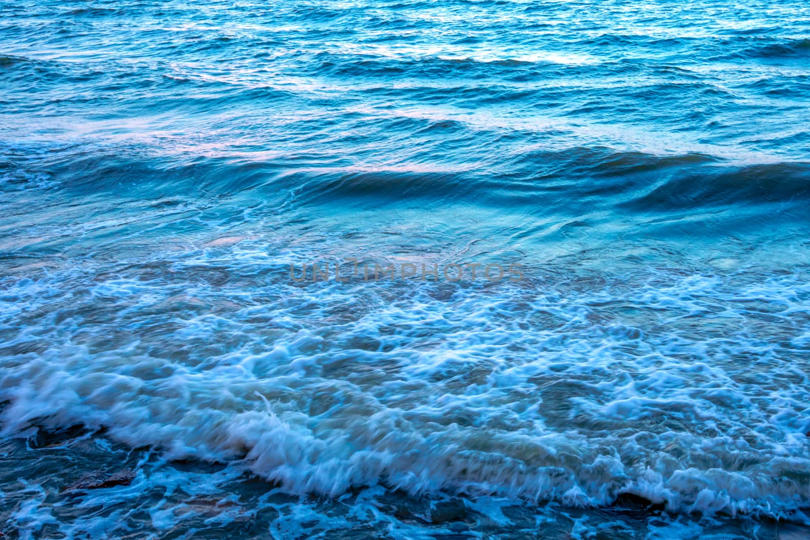 Light reflection on the surface of movement sea on sand beach