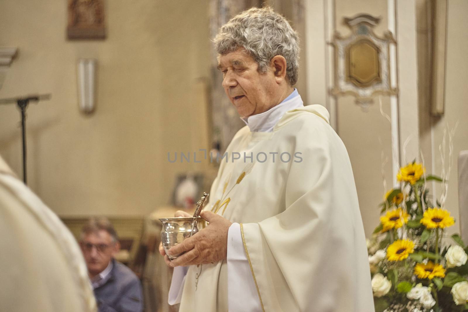 Priest celebrates the liturgy in a Catholic church in Italy