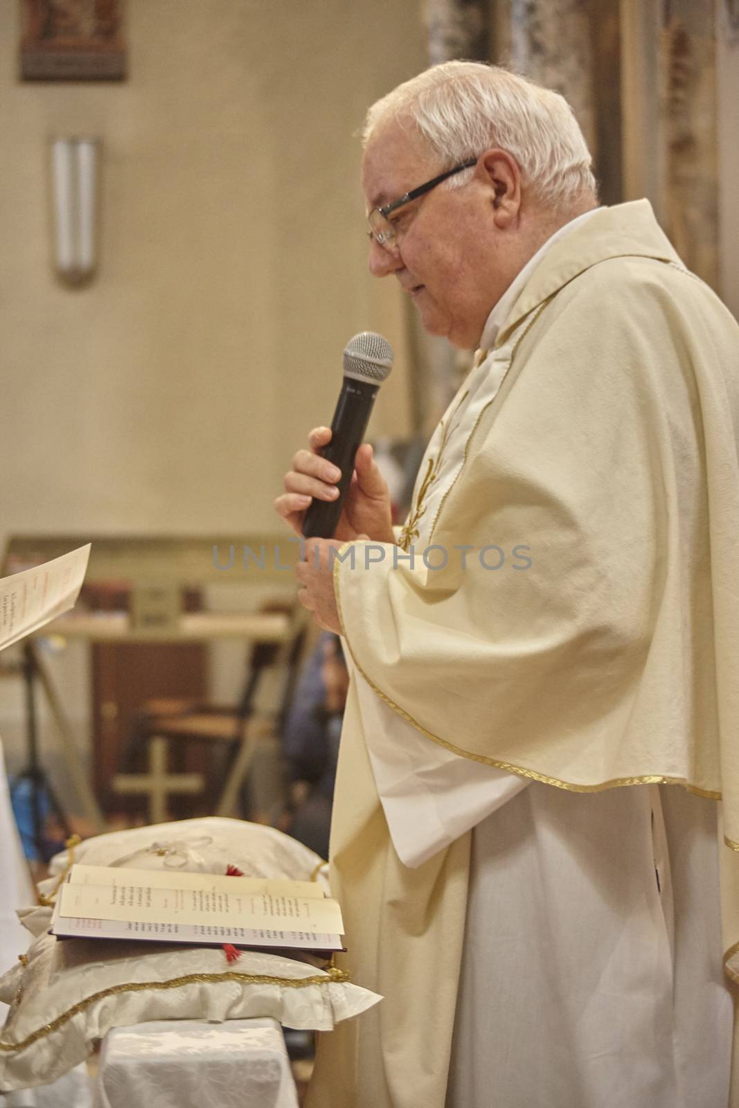 Priest celebrates the liturgy in a Catholic church in Italy