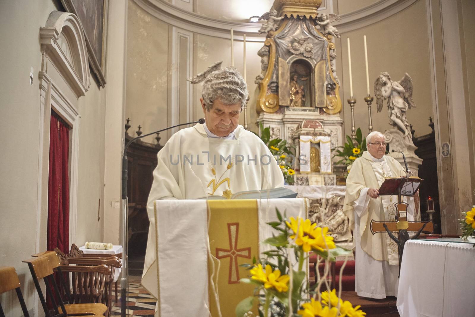 Priest celebrates the liturgy in a Catholic church in Italy