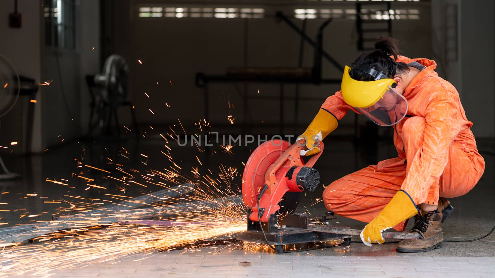Industrial worker cutting the steel to the size that the customer wants. For the real estate project received. Metal grinding on steel spare part in workshop.