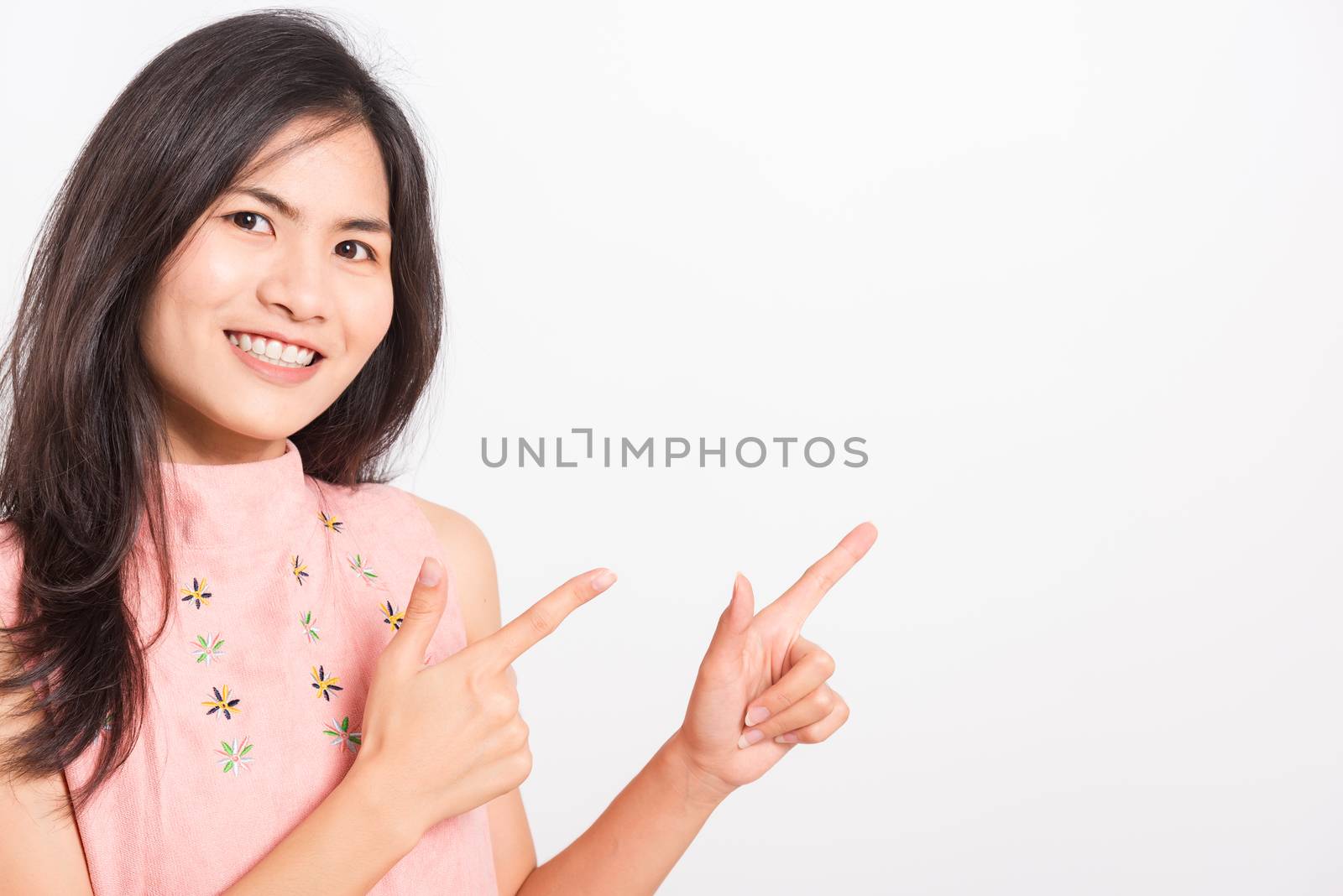 Portrait Asian beautiful young woman standing pointing finger up by Sorapop