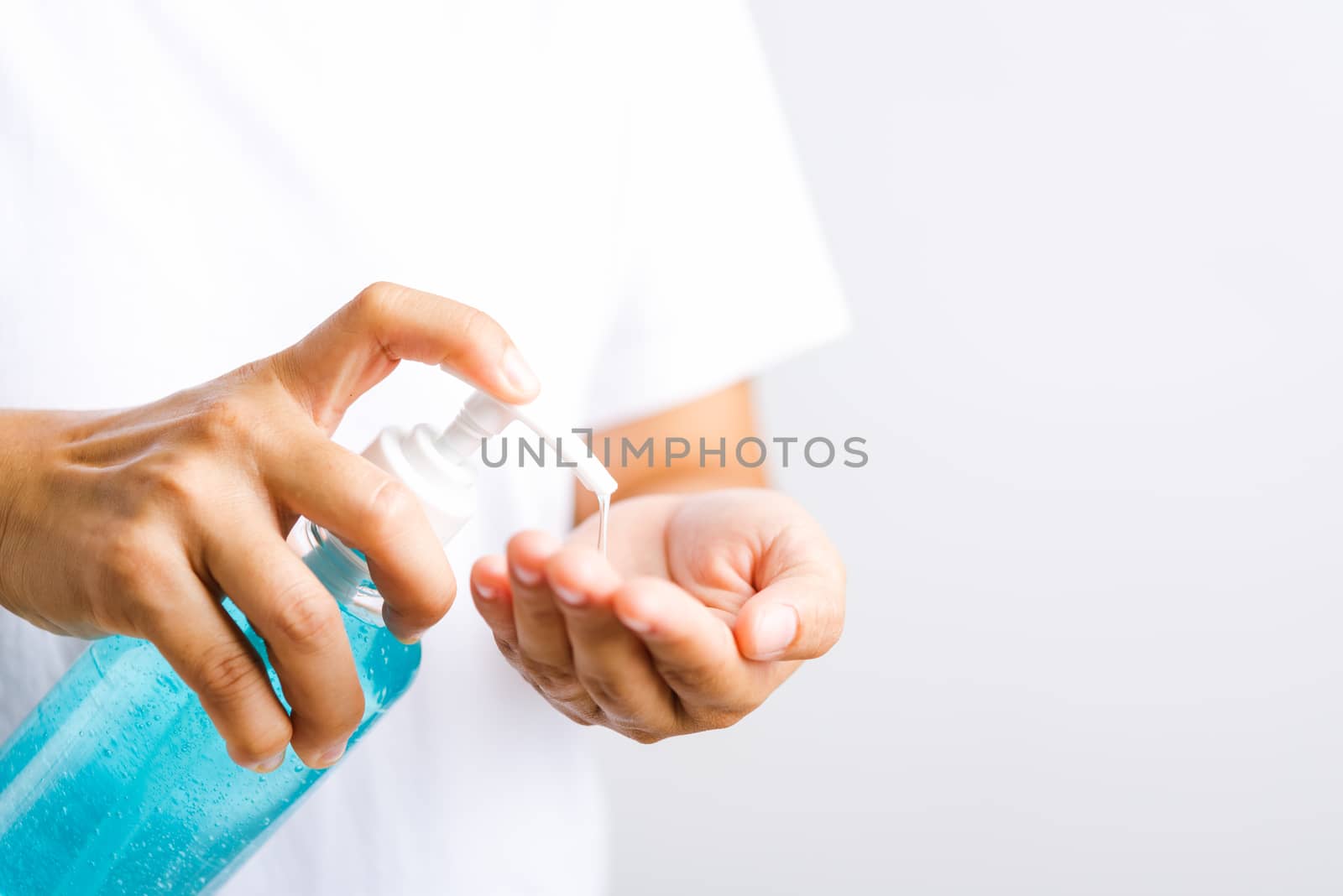 Closeup Hand Asian young woman applying pump dispenser sanitizer alcohol gel on hand wash cleaning, hygiene prevention COVID-19 or coronavirus protection concept, isolated on white background