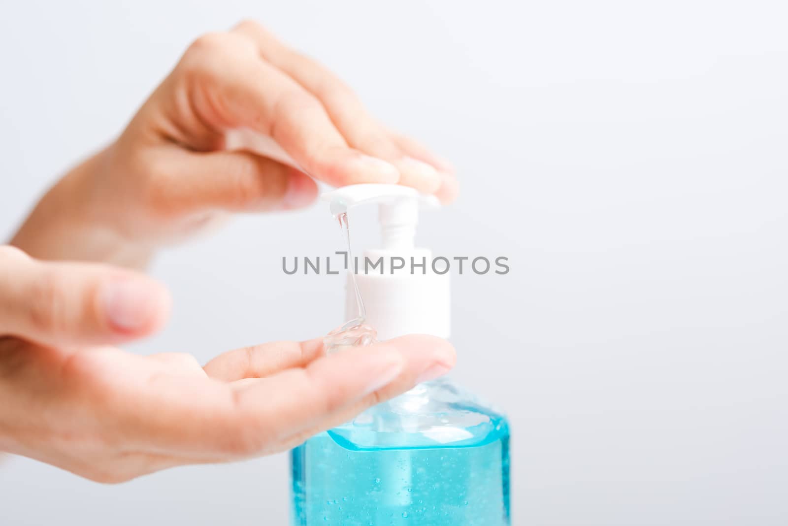 Close up Asian young woman applying press dispenser sanitizer alcohol gel pump to hand wash cleaning, hygiene prevention COVID-19 or coronavirus protection concept, isolated on white background