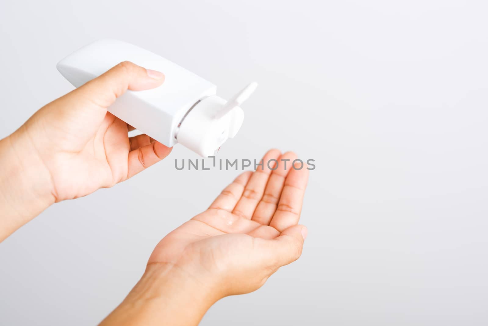 Closeup Hand Asian young woman applying drop dispenser sanitizer alcohol gel on hand wash cleaning, hygiene prevention COVID-19 or coronavirus protection concept, isolated on white background