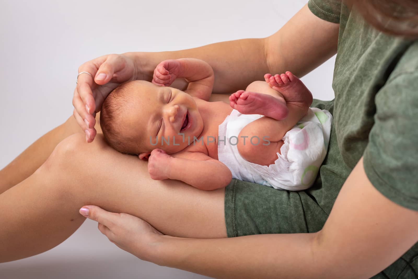 Beautiful new born baby resting on mom's hands by Vassiliy