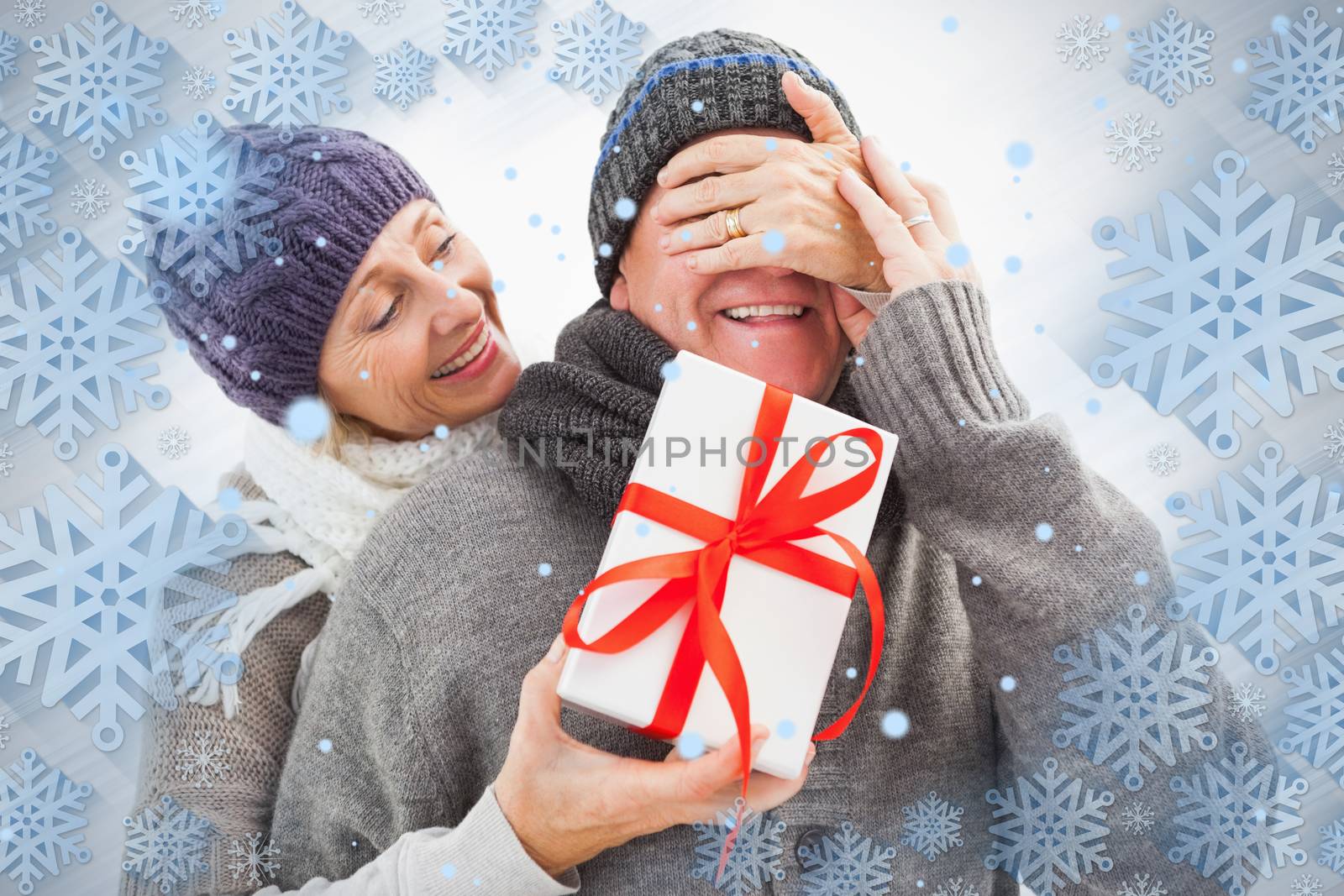 Happy mature woman hiding gift from partner by Wavebreakmedia