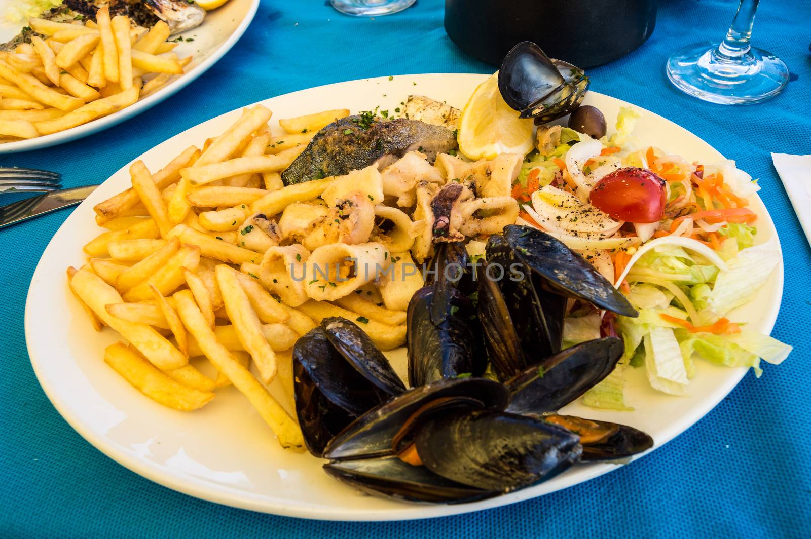 Seafood platter with fries and small vegetables in Malta