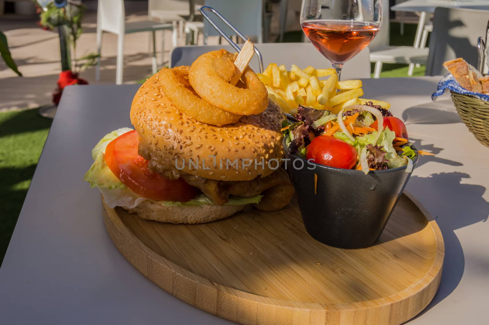 Chicken burger with fried calamari slices on a wooden board  by Philou1000