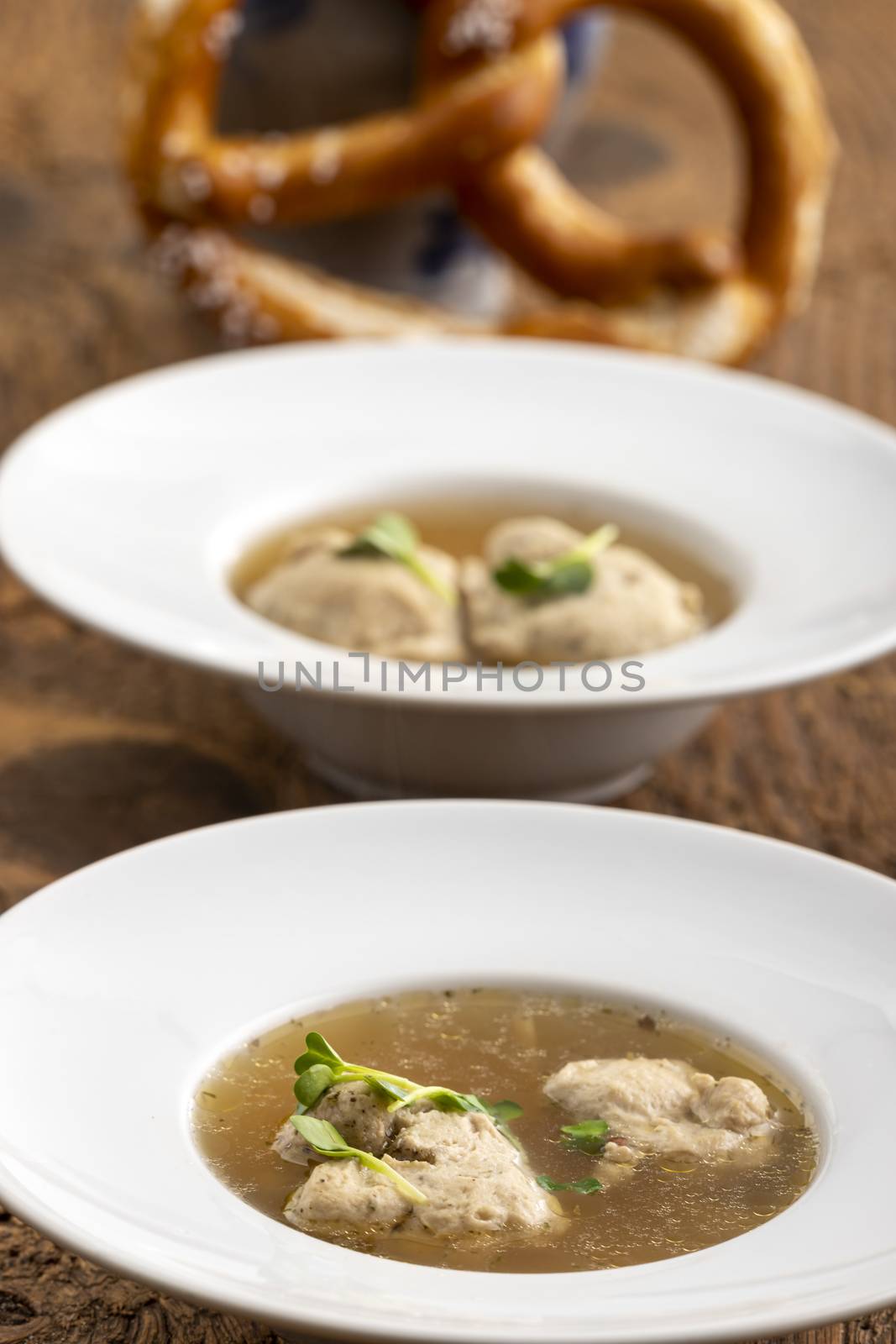 bavarian meat dumpling in broth on wood